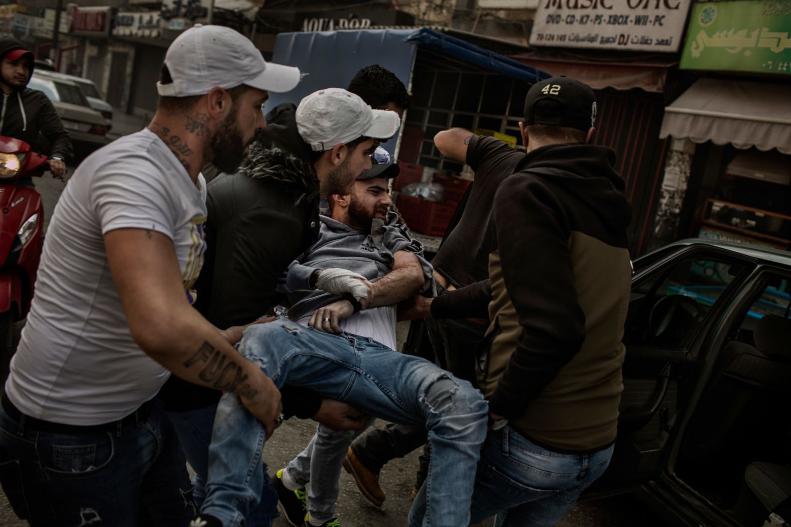 A protester is carried after being wounded by a rubber bullet.