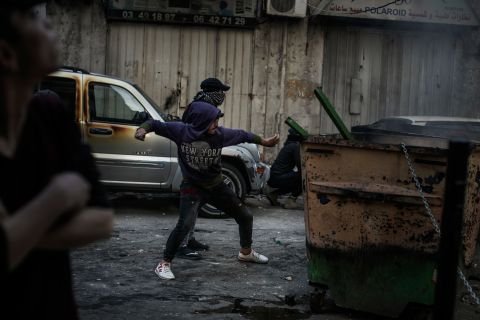 A protester throws a rock at soldiers on Tuesday. Demonstrations in Lebanon <a href="http://www.cnn.com/2019/10/29/world/gallery/lebanon-protests-political-crisis-intl/index.html" target="_blank">first began in October,</a> when the government proposed a tax on WhatsApp calls, along with other austerity measures. Hundreds of thousands of people took to the streets in a bubbling-over of fury at political elites.