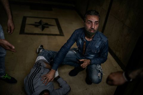 A protester lies on the floor after being wounded by a rubber bullet in Tripoli.