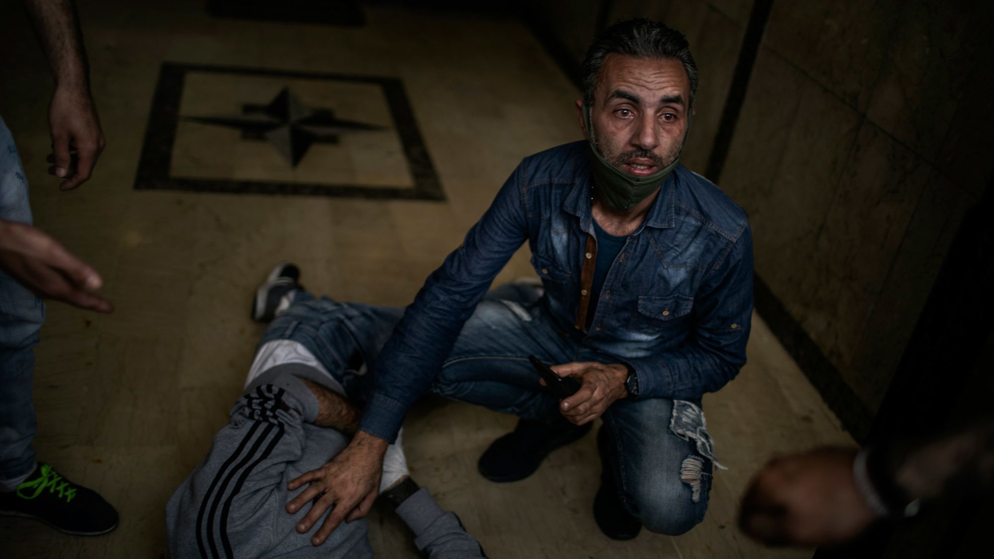 A protester lies on the floor after being wounded by a rubber bullet in Tripoli.