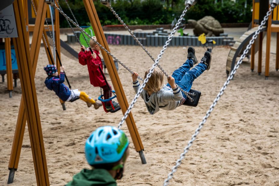 Children play on a public playground in Berlin on April 30. Many playgrounds were reopening for the first time.