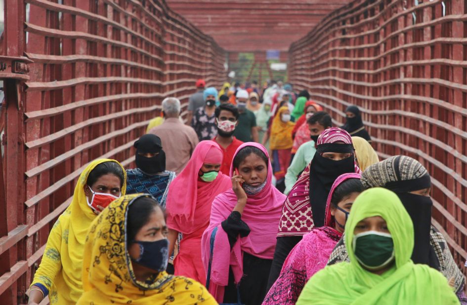 Garment workers wear face masks as they return to work in Dhaka, Bangladesh, on April 30. More than 500 garment factories in Bangladesh reopened.