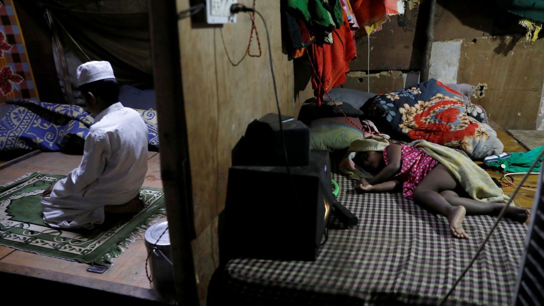 Rohingya refugee Shahid Hussain, 10, offers prayers after breaking fast in New Delhi on April 30. His 2-year-old sister, Sania, sleeps in the next room.