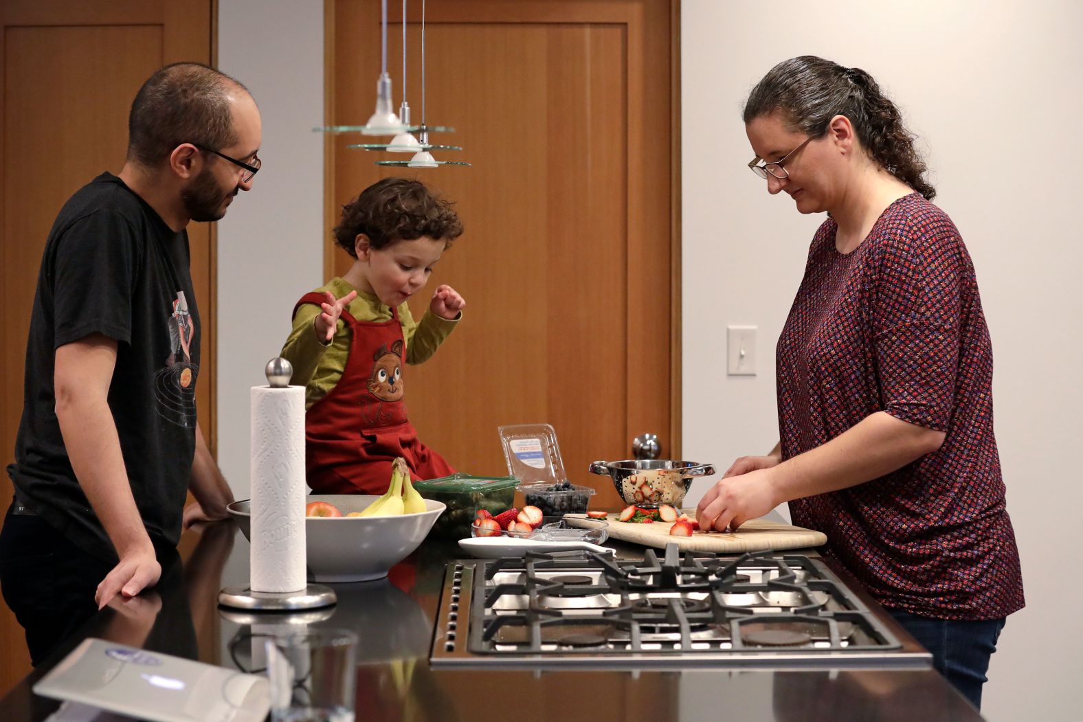 Yusuf Kamel, 2, watches his parents Ahmad Kamel and Nadia Chaouch prepare a meal to break their daily Ramadan fast in Seattle on April 28.