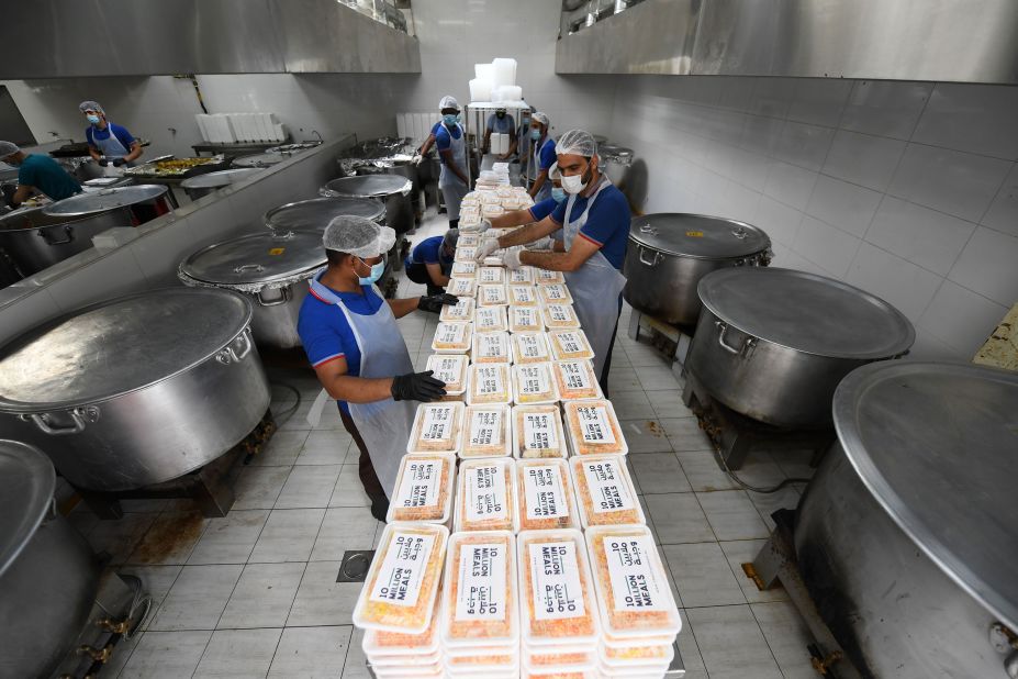 Volunteers prepare meals to be given to migrant workers in Dubai, United Arab Emirates, on April 28.