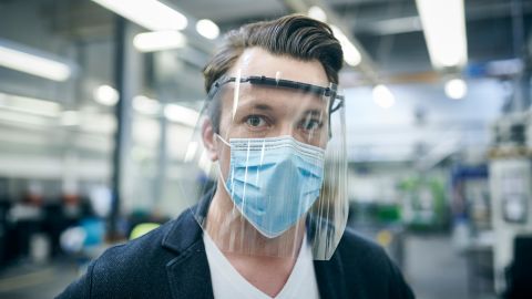 A Ford of Europe employee wearing protective equipment similar to that US employees will be required to wear.