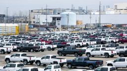 New vehicles sit in a lot in front of the idled General Motors Co. Flint Assembly plant in Flint, Michigan, U.S., on Monday, March 23, 2020. The auto industry is escalating its push for U.S. assistance to help weather the impact of a global pandemic that has halted or will soon stop production at 42 out of 44 plants that assemble vehicles in the country. Photographer: Anthony Lanzilote/Bloomberg via Getty Images