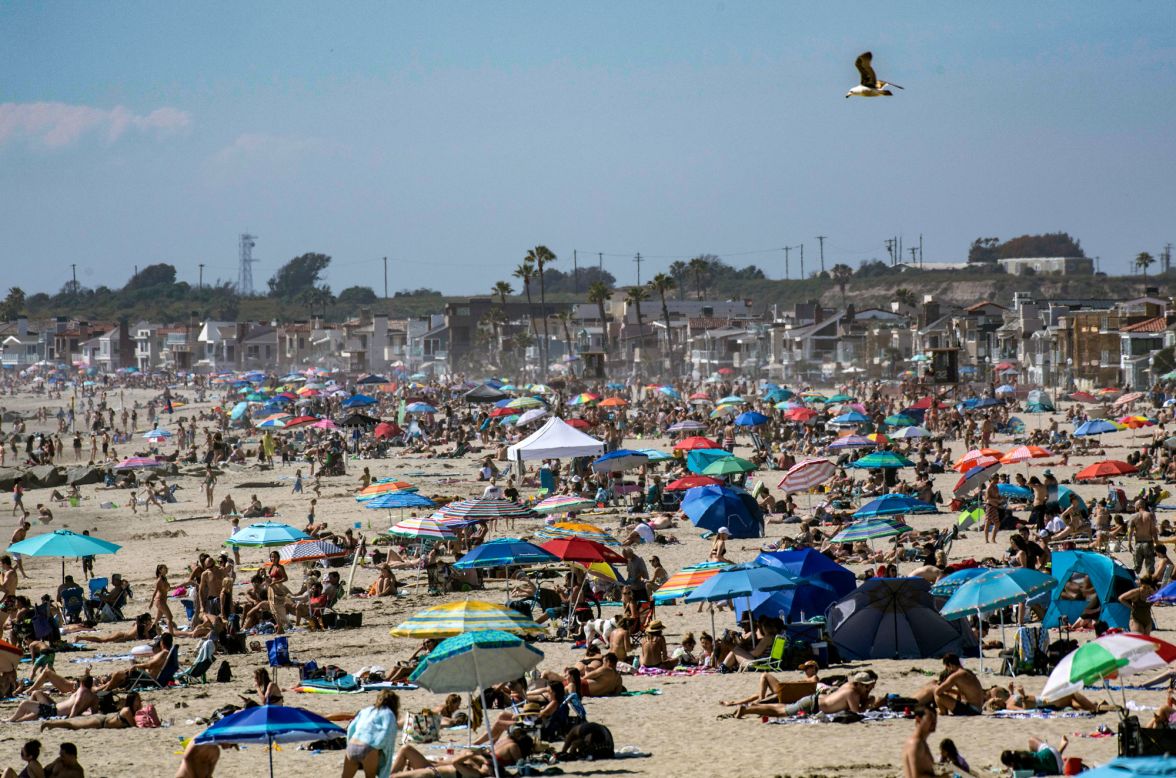 Crowds gather near the Newport Beach Pier in Newport Beach, California, on Saturday, April 25. California Gov. Gavin Newsom <a href="https://www.cnn.com/travel/article/california-newsom-close-beaches-parks/index.html" target="_blank">ordered the closure of Orange County beaches</a> on Thursday after crowds packed the waterfront there over the weekend. "This virus doesn't take the weekends off," he said.