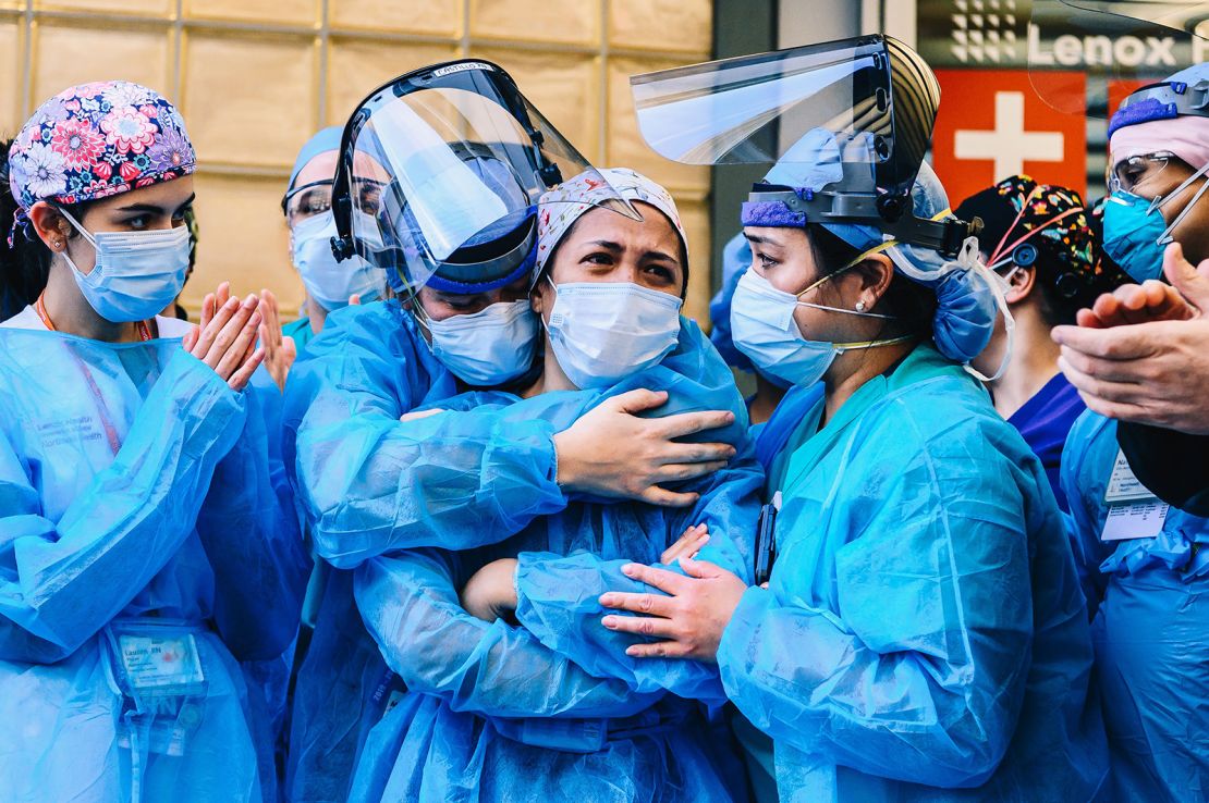 Medical workers embrace outside Lenox Health Greenwich Village on Thursday as New Yorkers applaud medical staff and essential workers on the front lines of the coronavirus pandemic.
