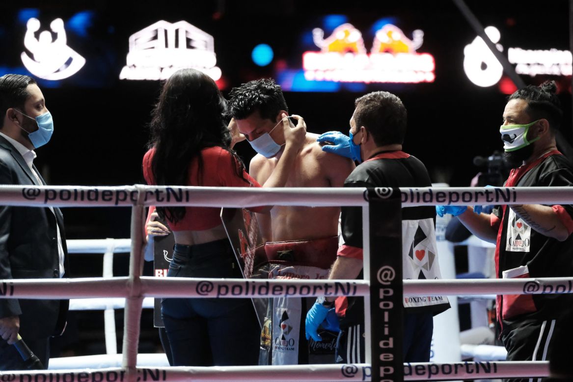 Boxer Robin Zamora has his face mask removed before a bout in Managua, Nicaragua, on Saturday, April 25. Several fights were held in front of spectators.