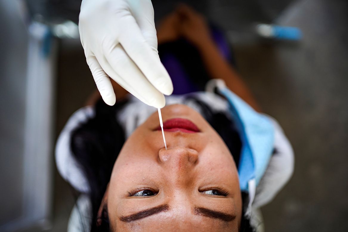 A nose swab test is performed on a resident of Bangkok, Thailand, on Tuesday, April 28.