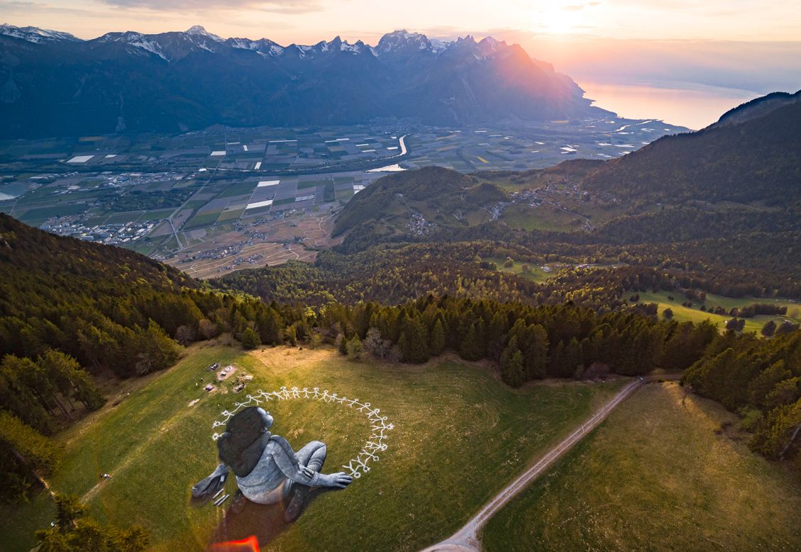 This aerial photo, taken on Friday, April 24, shows "Beyond Crisis," a giant artwork painted by the Swiss-French artist Saype in Leysin, Switzerland. The artwork covers 3,000 square meters (32,292 square feet) and was made with biodegradable paints made from natural pigments such as coal and chalk.