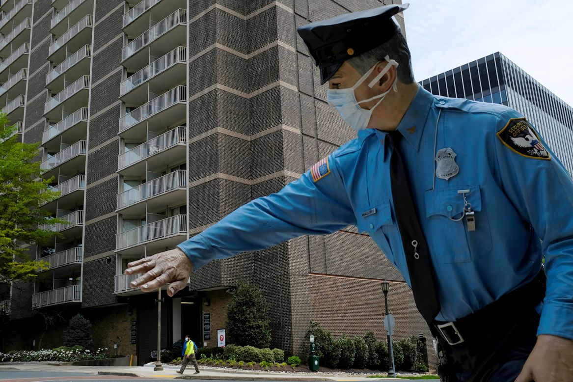 A face mask is seen on the statue of former police officer James McAuliffe in Chevy Chase, Maryland, on Wednesday, April 29.