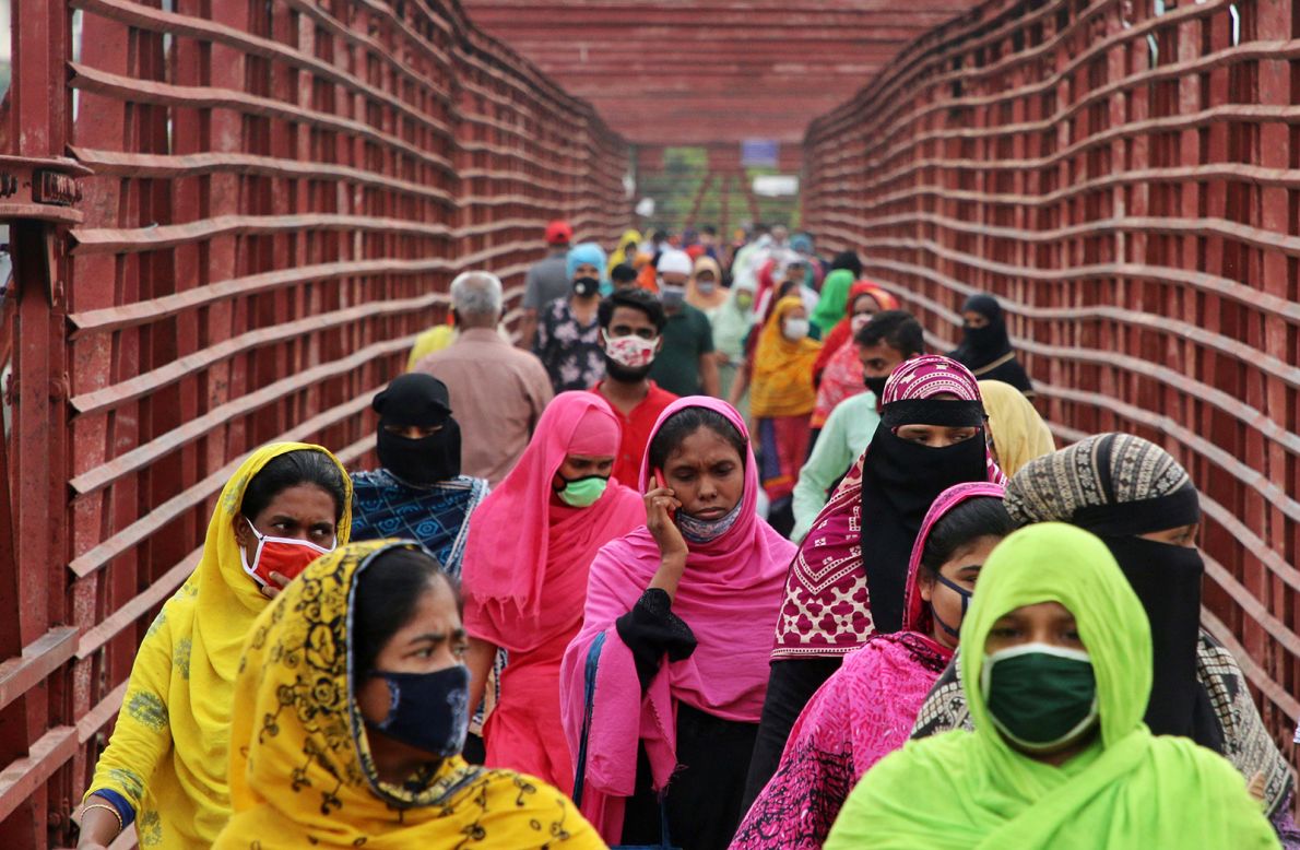Garment workers wear face masks as they return to work in Dhaka, Bangladesh, on Thursday, April 30. More than 500 garment factories in Bangladesh reopened this week.