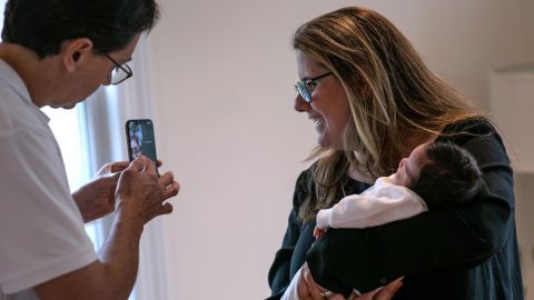 Luciana Lira and her husband Alex hold Neysel for a video chat with his family.