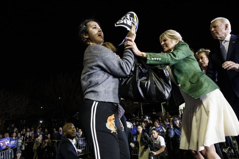 Biden's wife, Jill, blocks a protester who charged the stage during his Super Tuesday speech in Los Angeles in March 2020. The protester was holding a sign that said "Let dairy die."