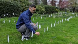 Patrick Collins, a pastor at First Congregational Church of Greenwich, plants flags to mark coronavirus deaths in Connecticut. 