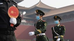 Paramilitary police officers wear face masks and goggles amid concerns of the COVID-19 coronavirus as they march outside the Forbidden City, the former palace of China's emperors, in Beijing on May 1, 2020. - China's Forbidden City reopened on May 1, three months after it closed due to the coronavirus crisis -- the latest signal that the country has brought the disease under control. (Photo by GREG BAKER / AFP) (Photo by GREG BAKER/AFP via Getty Images)