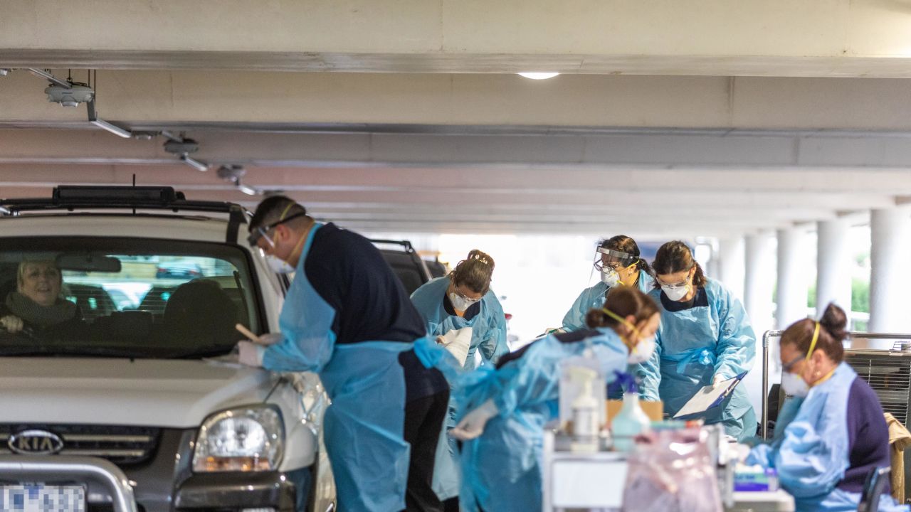 Medical practioners conducting tests for Covid-19 at a drive-thru testing facility in a parking lot on April 30 in Melbourne, Australia.