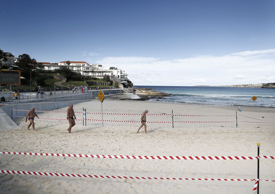A group of men walk on Bondi Beach on May 01 in Sydney, Australia, following the easing of lockdown measures in response to a decline in coronavirus cases across the state. 