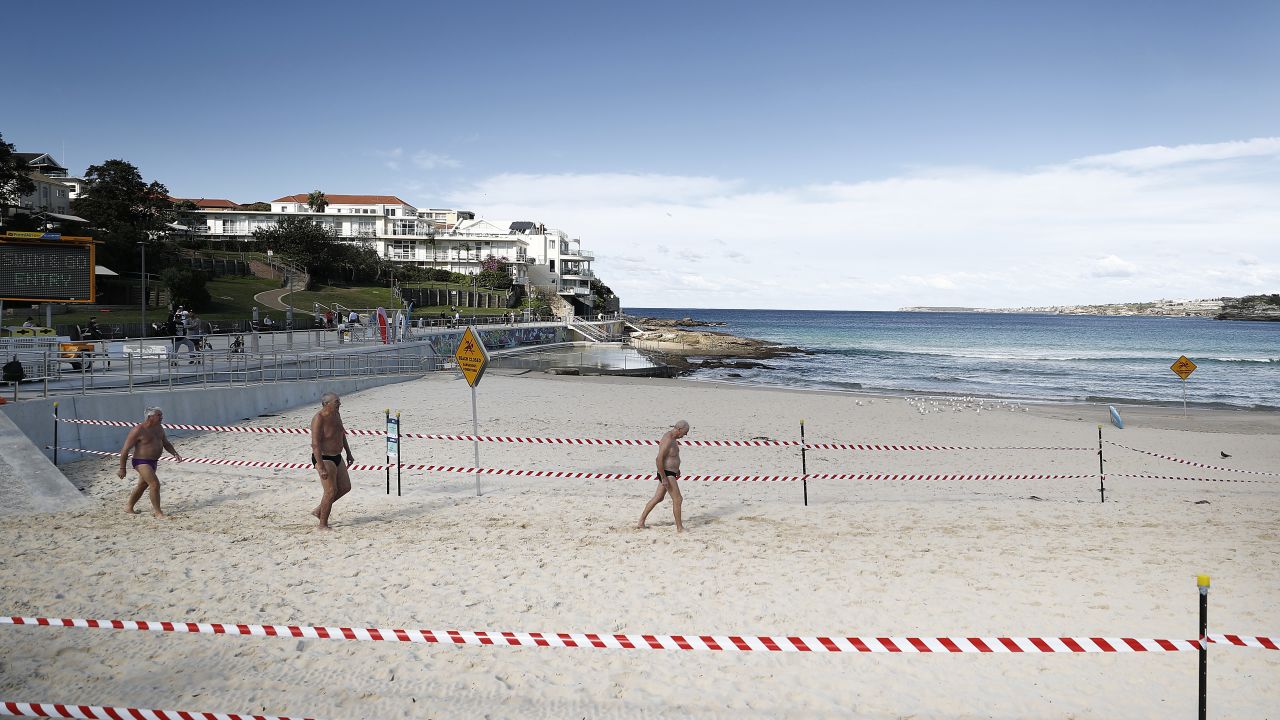 A group of men walk on Bondi Beach on May 01 in Sydney, Australia, following the easing of lockdown measures in response to a decline in coronavirus cases across the state.