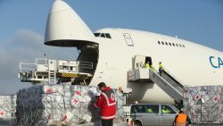 SCHOENEFELD, GERMANY - NOVEMBER 13:  A member of the German Red Cross (DRK) checks a shipment of aid destined for the Philippines at Schoenefeld Airport before the aid was loaded on to a Boeing 747 cargo plane on November 13, 2013 in Schoenefeld, Germany. The German government is sponsoring the aid, which includes tents, hygiene packages, equipment for producing drinkable water and other necessities, to help alleviate the plight of millions of people made homeless by typhoon Haiyan.  (Photo by Sean Gallup/Getty Images)