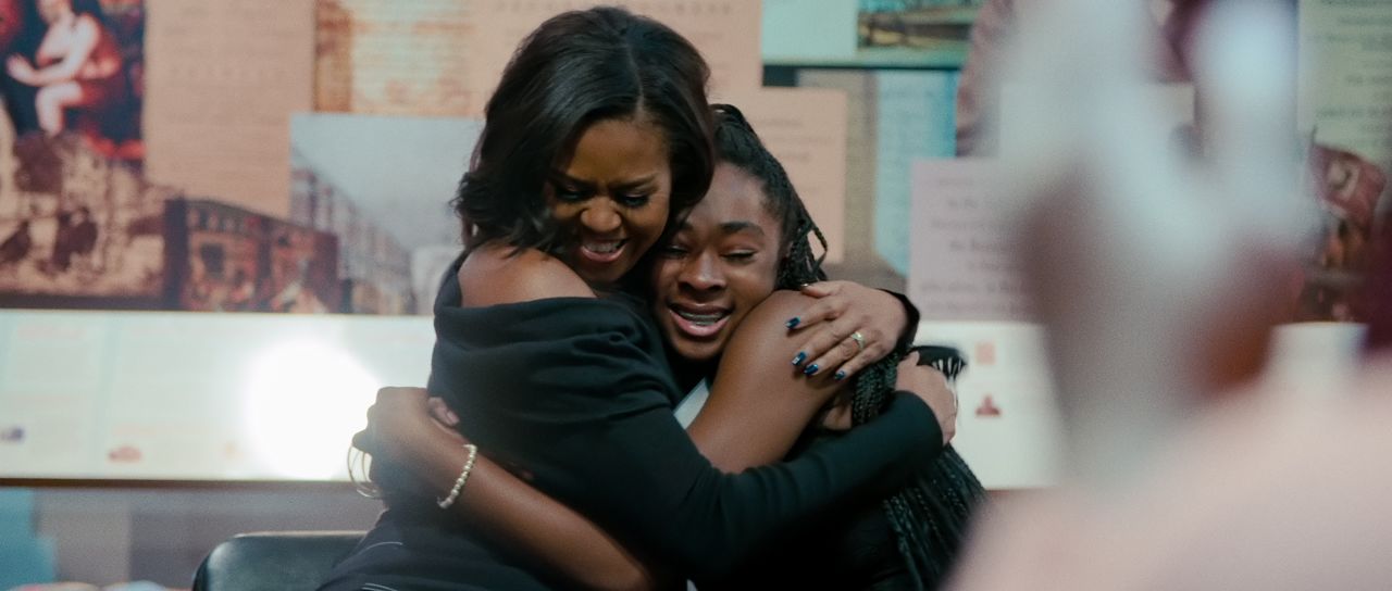 Obama shares a hug with a fan in her 2020 Netflix documentary "Becoming," just one of the media projects she's been involved with this year. The Obamas signed a multi-year production deal with the streaming company in 2018, and in July 2020 the former first lady launched a podcast.