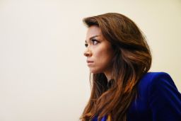 Chanel Rion listens as U.S President Donald Trump speaks during a news conference at the White House. (Jim Lo Scalzo/EPA/Bloomberg via Getty Images)