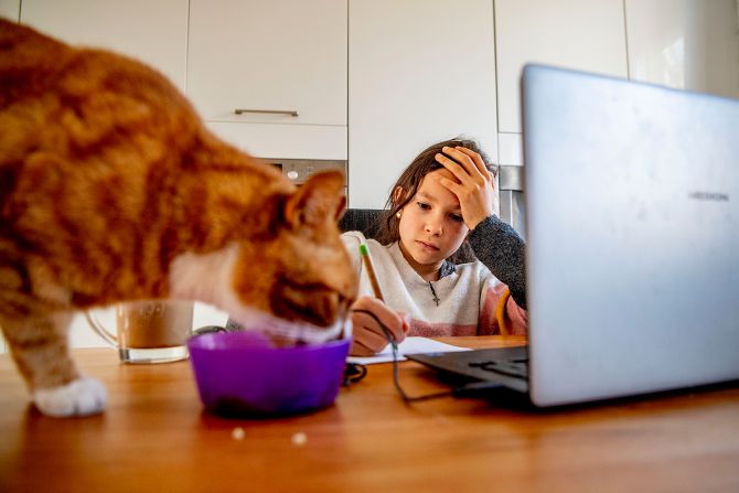 A girl in Rotterdam, Netherlands, takes notes at home while being taught online on April 20.