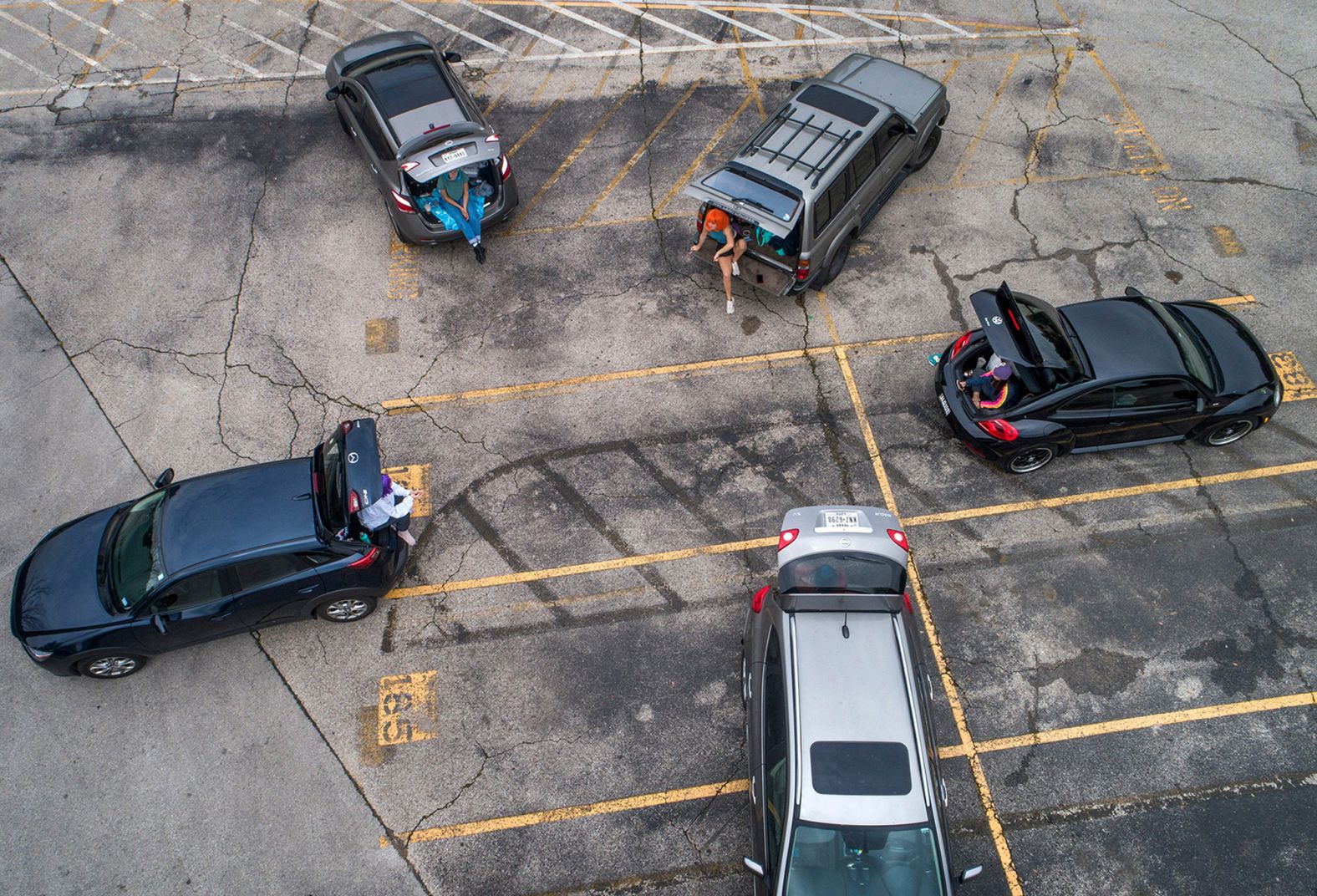 Best friends from Austin, Texas, visit one another in the parking lot of Austin High School on April 5. The seniors, clockwise from top left, are Brooke Peterman, Maddy McCutchin, Lucia Saenz, Reese Simek and Lily Tickle.