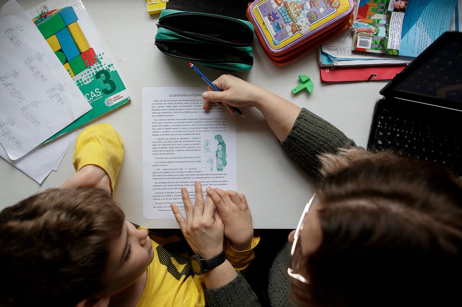 A boy in Madrid studies at home with his mother on April 15.