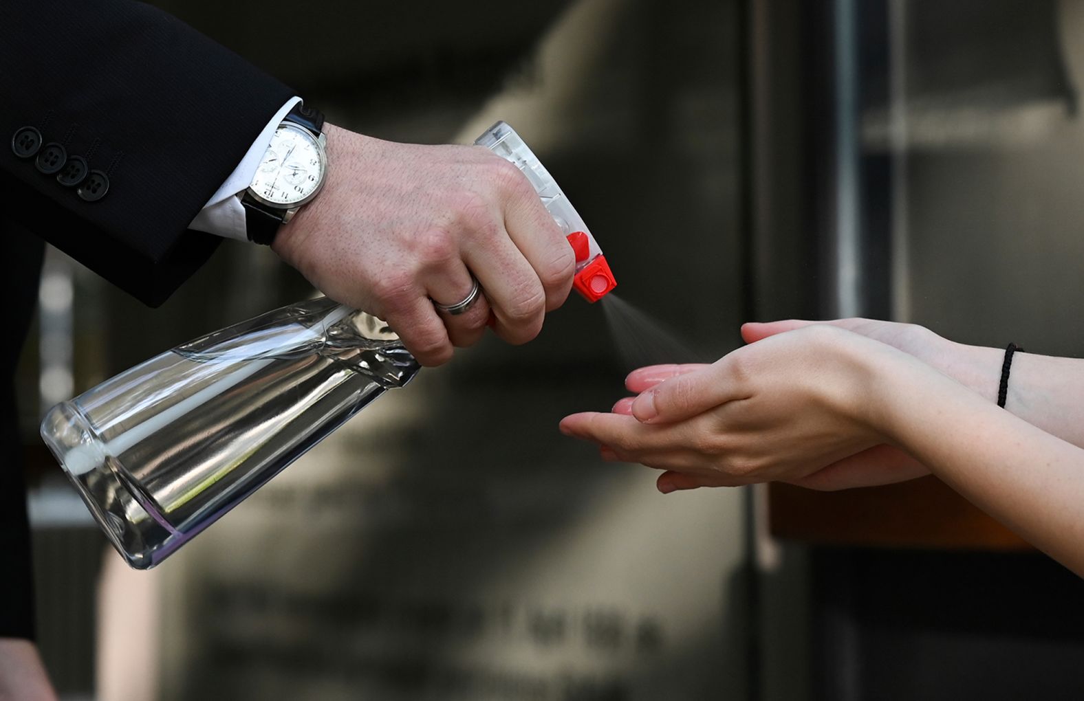 Headmaster Gerhard Köhler sprays disinfectant on the hands of a student before they entered a secondary school in Frankfurt, Germany, on April 27.