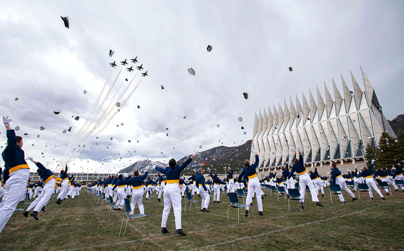 Air Force Academy cadets, spaced 8 feet apart, celebrate <a href="index.php?page=&url=https%3A%2F%2Fwww.cnn.com%2F2020%2F04%2F18%2Fpolitics%2Fmike-pence-air-force-academy-commencement-speech%2Findex.html" target="_blank">their graduation</a> as fighter jets fly overhead on April 18.