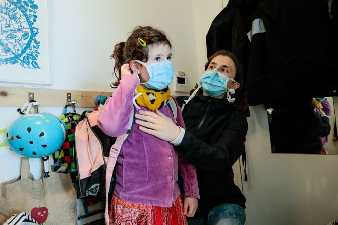 A child adjusts her mask before returning to school in Paris on April 27.