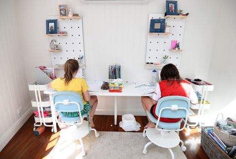Audrey Merriman, right, and her sister Grace learn from home in Brisbane, Australia, on April 20.