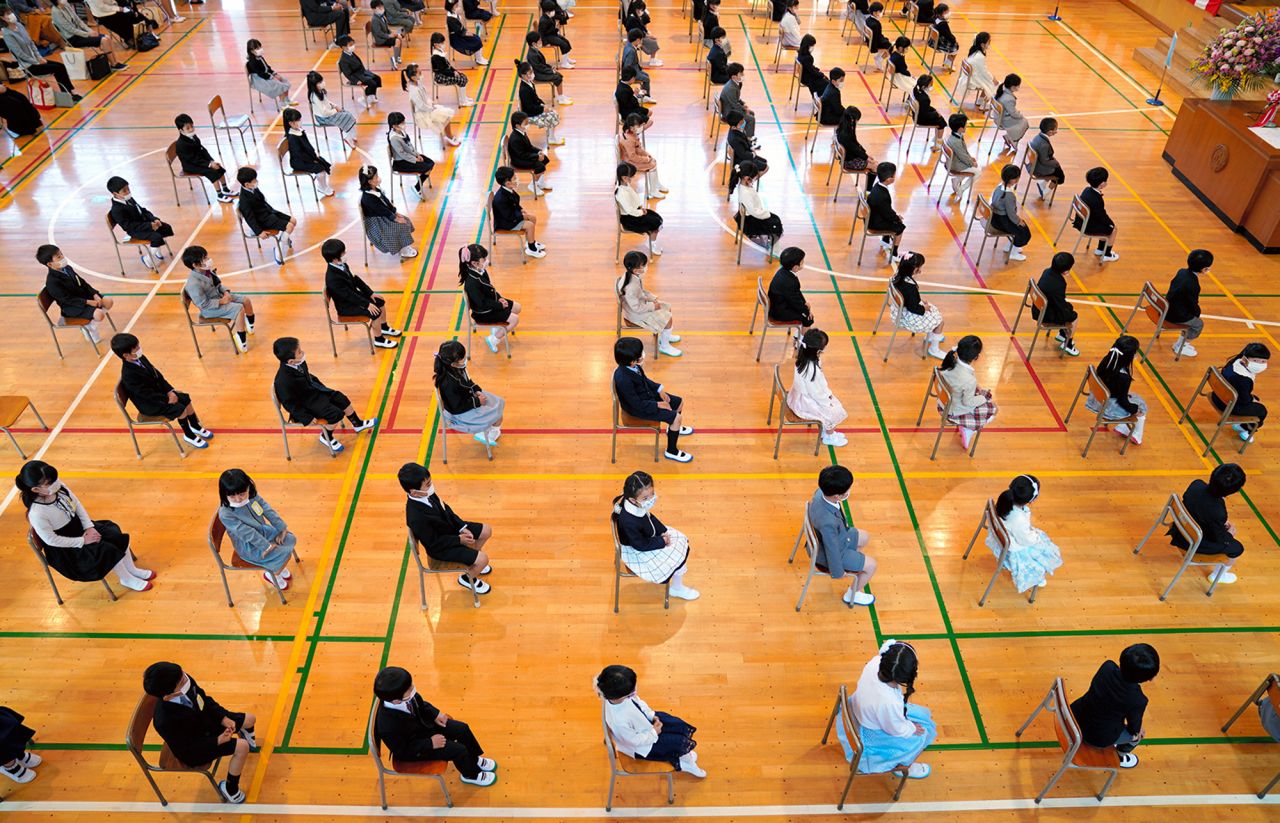 Students wear face masks and keep their distance from one another as a new school year starts in Yokohama, Japan, on April 6.