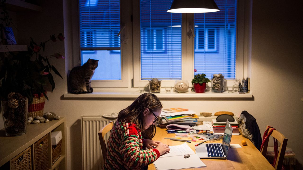 TOPSHOT - Jana(11) does her homework at her home during the lockdown of schools caused by the spread of the new coronavirus COVID-19 in Bratislava on March 27, 2020. - The newly-appointed government of new PM Igor Matovic came up with a new set of precautionary measures against the spread of the new coronavirus as obligatory face masks, specific shopping hours for elders and continuation of lockdown of schools. Slovakia has 269 positively tested cases of Covid 19. (Photo by VLADIMIR SIMICEK / AFP) (Photo by VLADIMIR SIMICEK/AFP via Getty Images)