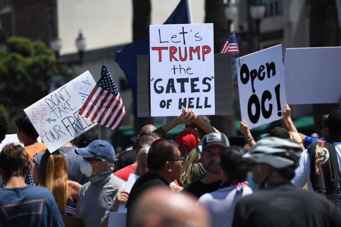 Demonstrators protest in Huntington Beach against the order closing beaches in Orange County, California.