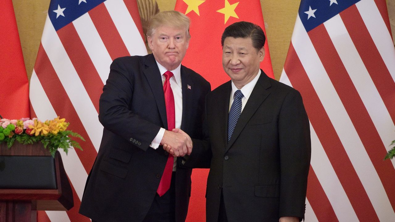 US President Donald Trump (L) shakes hands with China's President Xi Jinping during a press conference at the Great Hall of the People in Beijing on November 9, 2017.