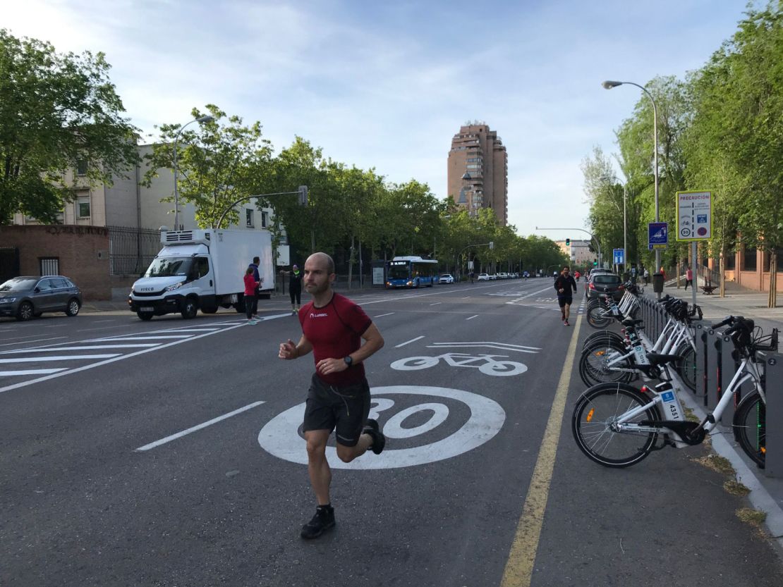 Runners outside Madrid's Retiro Park, which remains closed, on Saturday morning. Several ran in the roads, where there was little traffic.