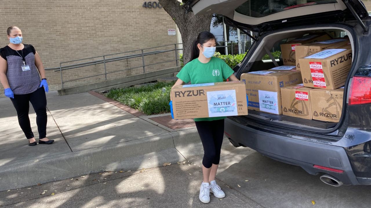 Xu unloading boxes of masks she paid for with funds raised through an online campaign. 