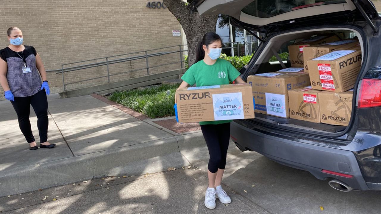 Xu unloading boxes of masks she paid for with funds raised through an online campaign.