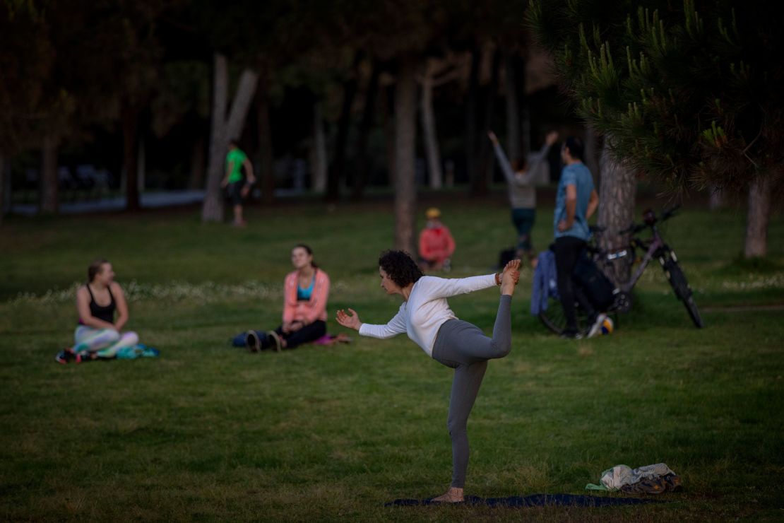 A woman exercises in a park in Barcelona on Saturday as people were given permission to exercise outside after seven weeks of confinement because of the coronavirus pandemic.