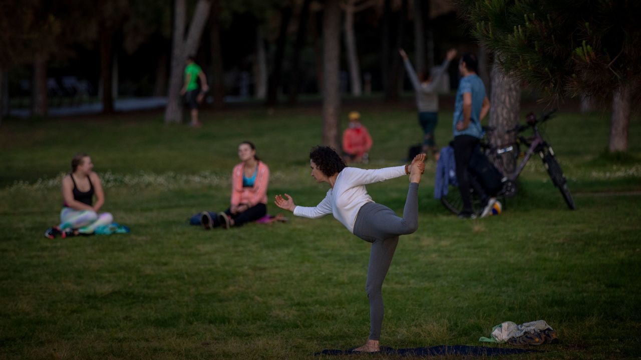A woman exercises in a park in Barcelona on Saturday as people were given permission to exercise outside after seven weeks of confinement because of the coronavirus pandemic.