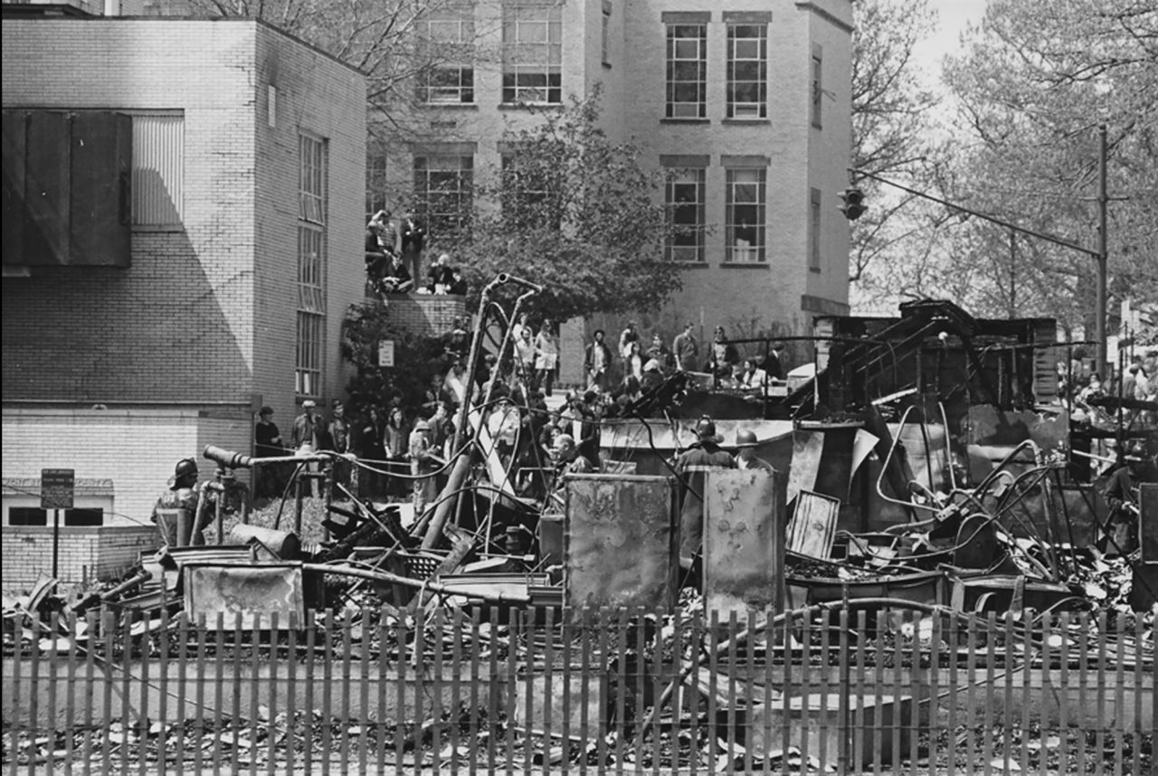 A night of violence in downtown Kent was followed by a student march to the campus ROTC building the next day. Some students tried to burn the building down. While the protesters claimed they left the building intact and in the hands of campus police when they returned to their dorms, the building was destroyed. It's still not clear who burned it down.