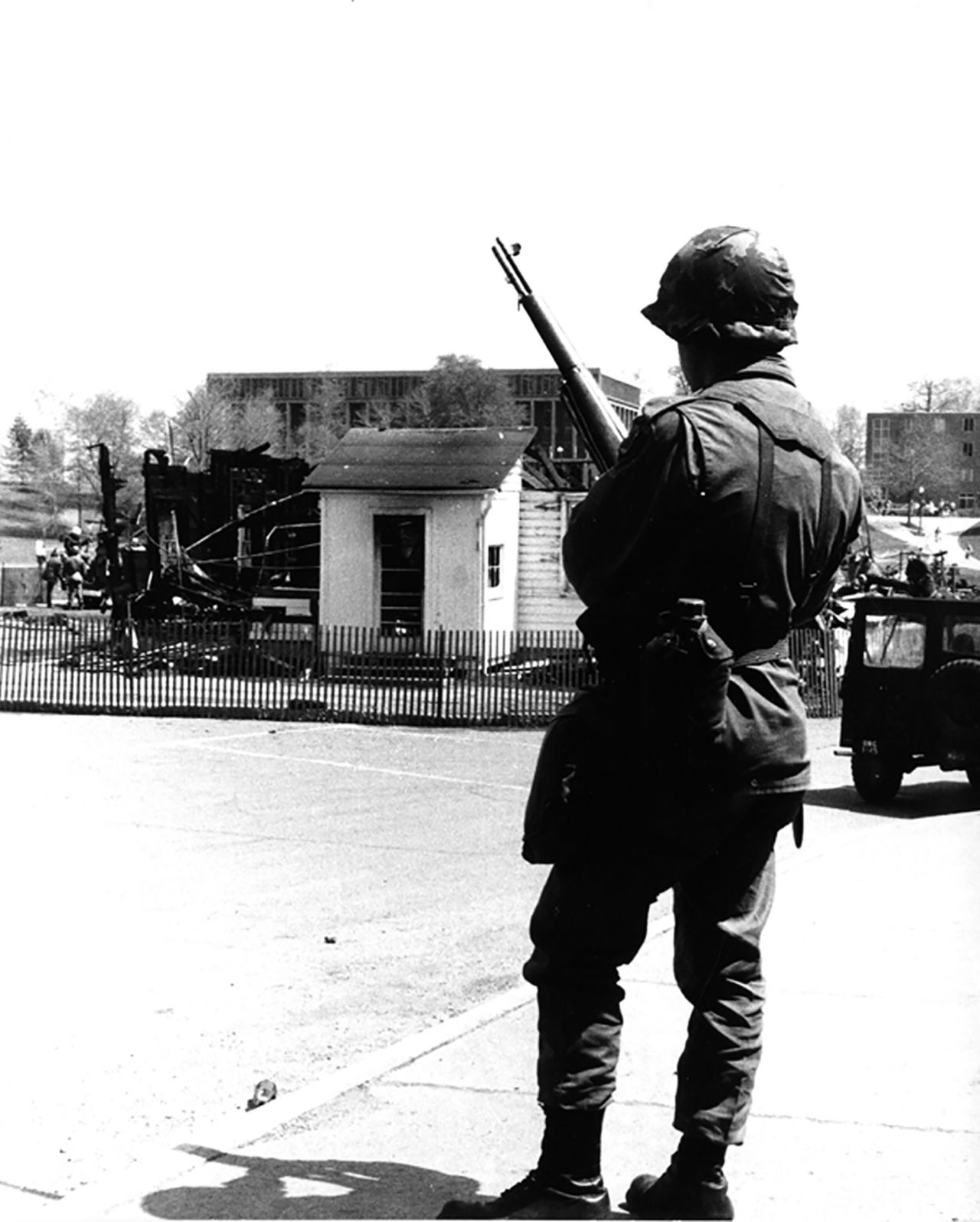 Guardsmen patrol the area around the burned-down ROTC building.