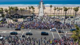 HUNTINGTON BEACH, CA - MAY 01:  An aerial view shows a crowd of protesters calling to reopen businesses and beaches as the growing the coronavirus pandemic continues to cripple the economy on May 1, 2020 in Huntington Beach, California.in reaction to the big crowds gathered together at Huntington and other Orange County beaches, California Gov. Gavin Newsom ordered a temporary closure of beaches in Orange County just before May Day. Orange County officials want the beaches re-opened. In Los Angeles County, beaches remain closed under social-distancing mandates to fight the spread of virus that causes COVID-19.   (Photo by David McNew/Getty Images)