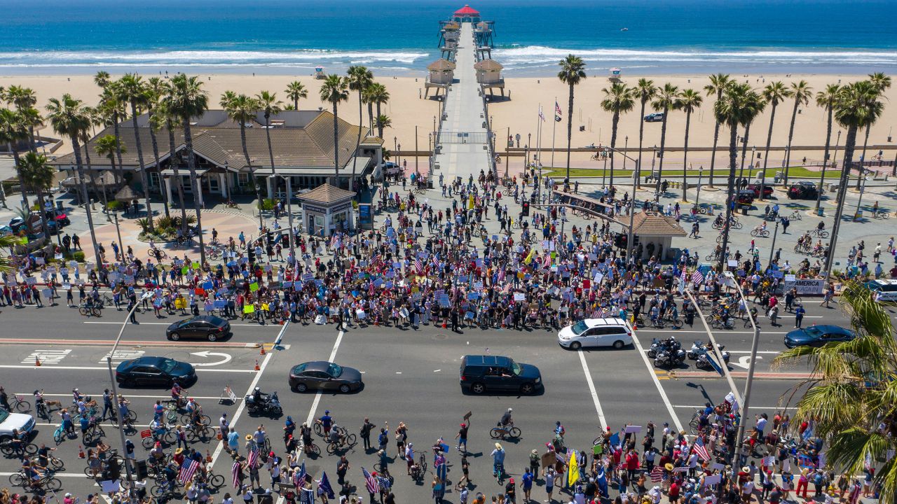  An aerial view shows a crowd of protesters calling to reopen businesses and beaches as the growing the coronavirus pandemic continues to cripple the economy in Huntington Beach, California Friday.