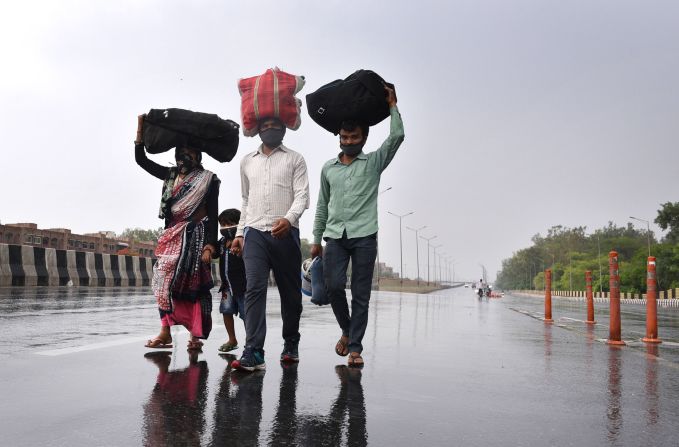 Migrant workers in New Delhi walk toward the Sarai Kale Khan Bus Terminus after learning that the government was preparing to send migrant workers back to their home states during a lockdown. In March 2020, Prime Minister Narendra Modi <a href="index.php?page=&url=http%3A%2F%2Fwww.cnn.com%2F2020%2F03%2F30%2Findia%2Fgallery%2Findia-lockdown-migrant-workers%2Findex.html" target="_blank">urged all states to seal their borders</a> to stop the coronavirus from being imported into rural areas.