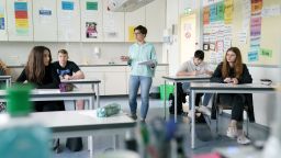 ETTLINGEN, GERMANY - MAY 04: Class teacher Katharina Schneider welcomes back a group of tenth graders who will soon face exams at the Schillerschule school during the novel coronavirus crisis on May 4, 2020 in Ettlingen, Germany.. (Photo by Matthias Hangst/Getty Images)